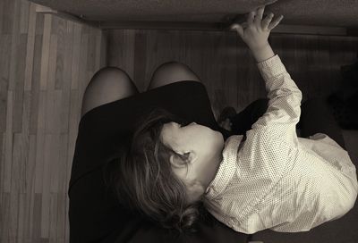 Portrait of woman lying on bed at home