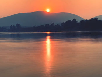 Scenic view of lake against romantic sky at sunset