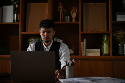 Businessman working on laptop at office