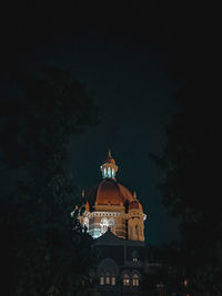 Low angle view of illuminated building against sky at night