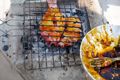 High angle view of meat on barbecue grill