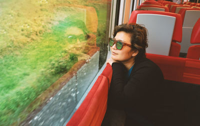 Woman looking through train window