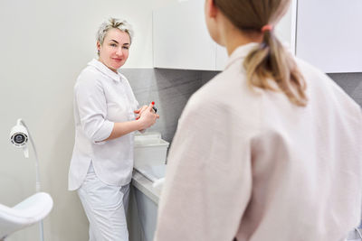 Gynecologist talking with patient at clinic