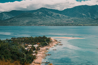 Scenic view of sea and mountains against sky