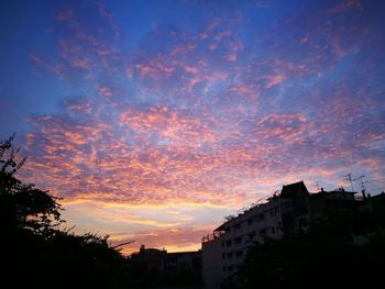 Low angle view of silhouette buildings against sky during sunset