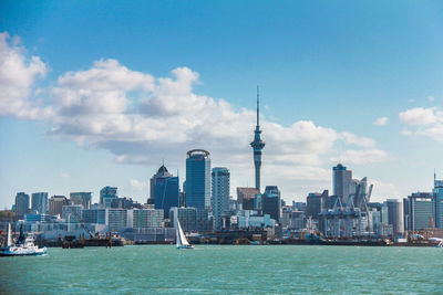 Modern buildings in city against cloudy sky