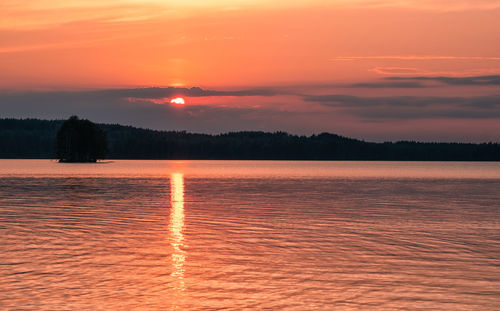 Scenic view of lake against romantic sky at sunset