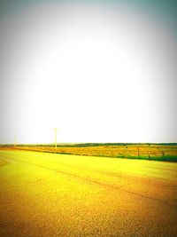 Scenic view of agricultural field against clear sky