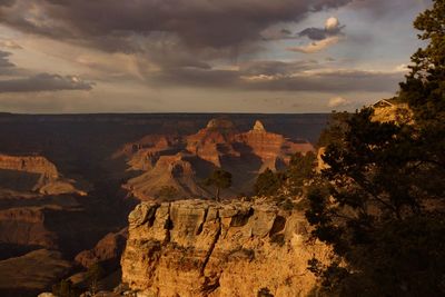 Scenic view of rock formations against cloudy sky