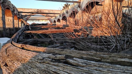 Abandoned wooden bridge against sky