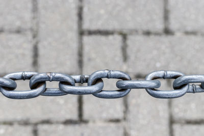 Close-up of chain against wall