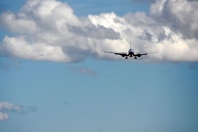 Low angle view of airplane flying in sky