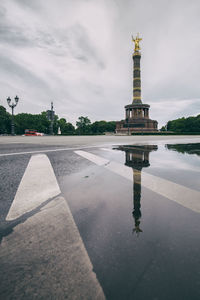 Reflection of built monument against clouds