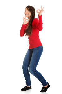 Happy woman standing against white background