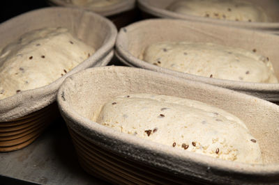 Raw wholemeal cereal bread dough in a dish lined with baking cloth. craft bakery. healthy  food