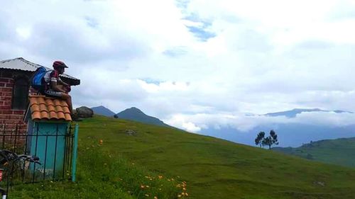 Scenic view of landscape against cloudy sky