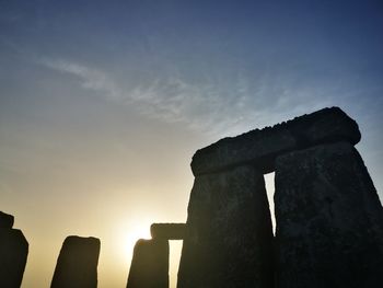 Low angle view of old ruin against sky during sunset