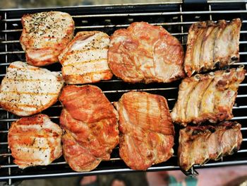 High angle view of meat on barbecue grill