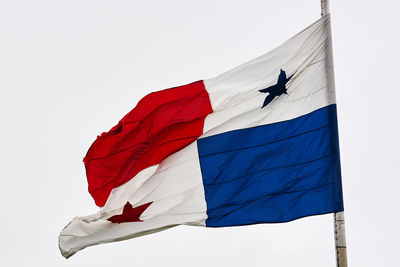 Low angle view of flag against clear sky