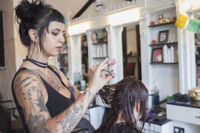 A hair dresser styling a customer's hair.