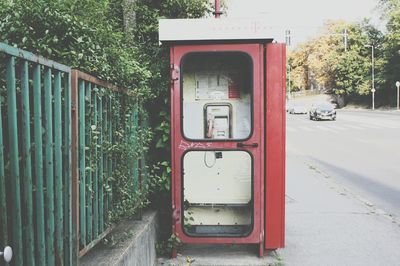 Red telephone booth on street