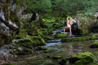 Stream flowing through rocks in forest