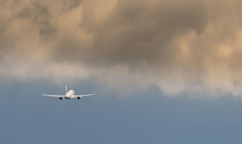 Low angle view of airplane flying in sky