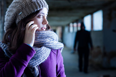 Portrait of young woman standing in snow