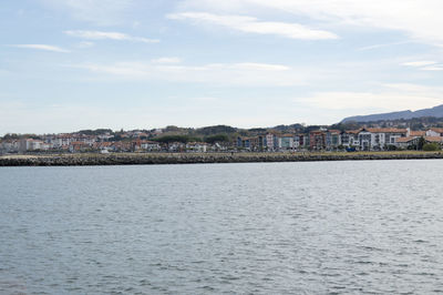 View of town by sea against sky