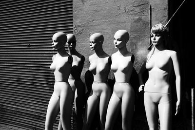 Mannequins by building on sunny day