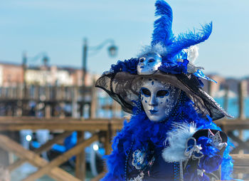 Close-up of woman wearing venetian mask and costume