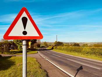 Road sign against sky