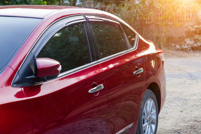 Close-up of red car on road