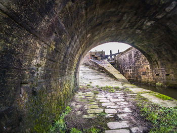 Arch bridge amidst trees in tunnel