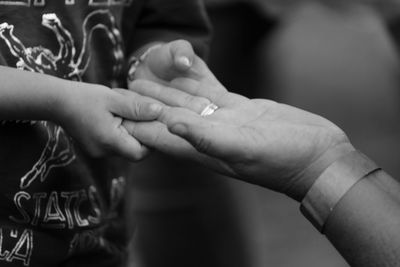 Midsection of couple holding hands