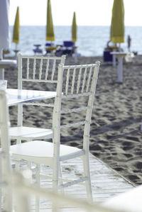 Empty chairs on beach