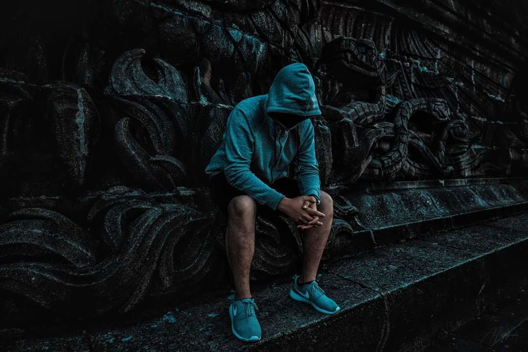 full length, one person, real people, lifestyles, casual clothing, architecture, leisure activity, wall - building feature, graffiti, day, hood, staircase, men, young adult, clothing, front view, abandoned, indoors, old, hood - clothing, deterioration