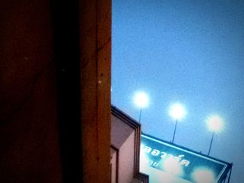 Low angle view of illuminated building against sky at night