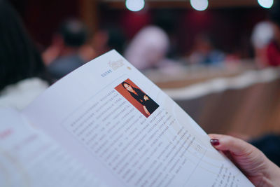 Close-up of hand holding book