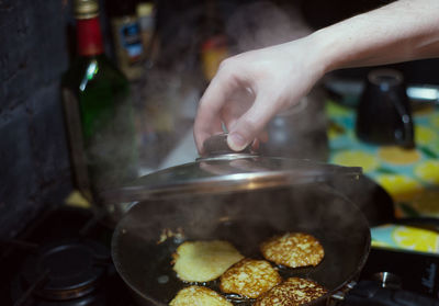 Person holding ice cream in kitchen