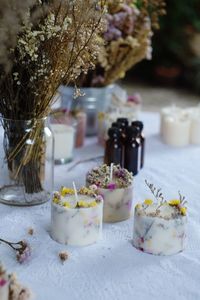 High angle view of candles with flowers on table