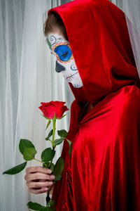 Woman holding a red rose