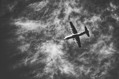 Low angle view of airplane flying in sky