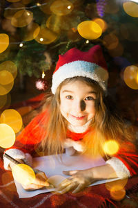 Portrait of smiling girl in santa costume