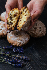 Close-up of hand holding bread on table