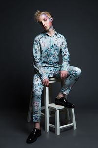 Woman looking away against black background