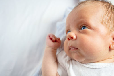 Close-up of cute baby boy sleeping on bed at home