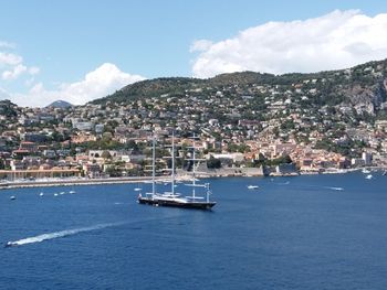 Scenic view of sea and town against sky