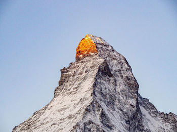 Low angle view of rock formation against clear sky - sunrise, matterhorn