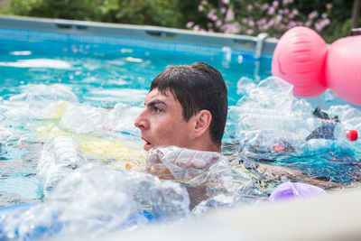 Portrait of man swimming in pool